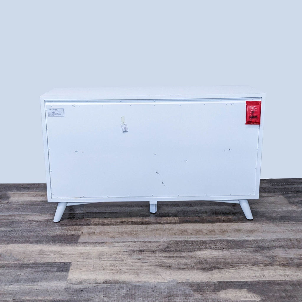 Back view of Tranquility dresser, showcasing smooth white paneling.