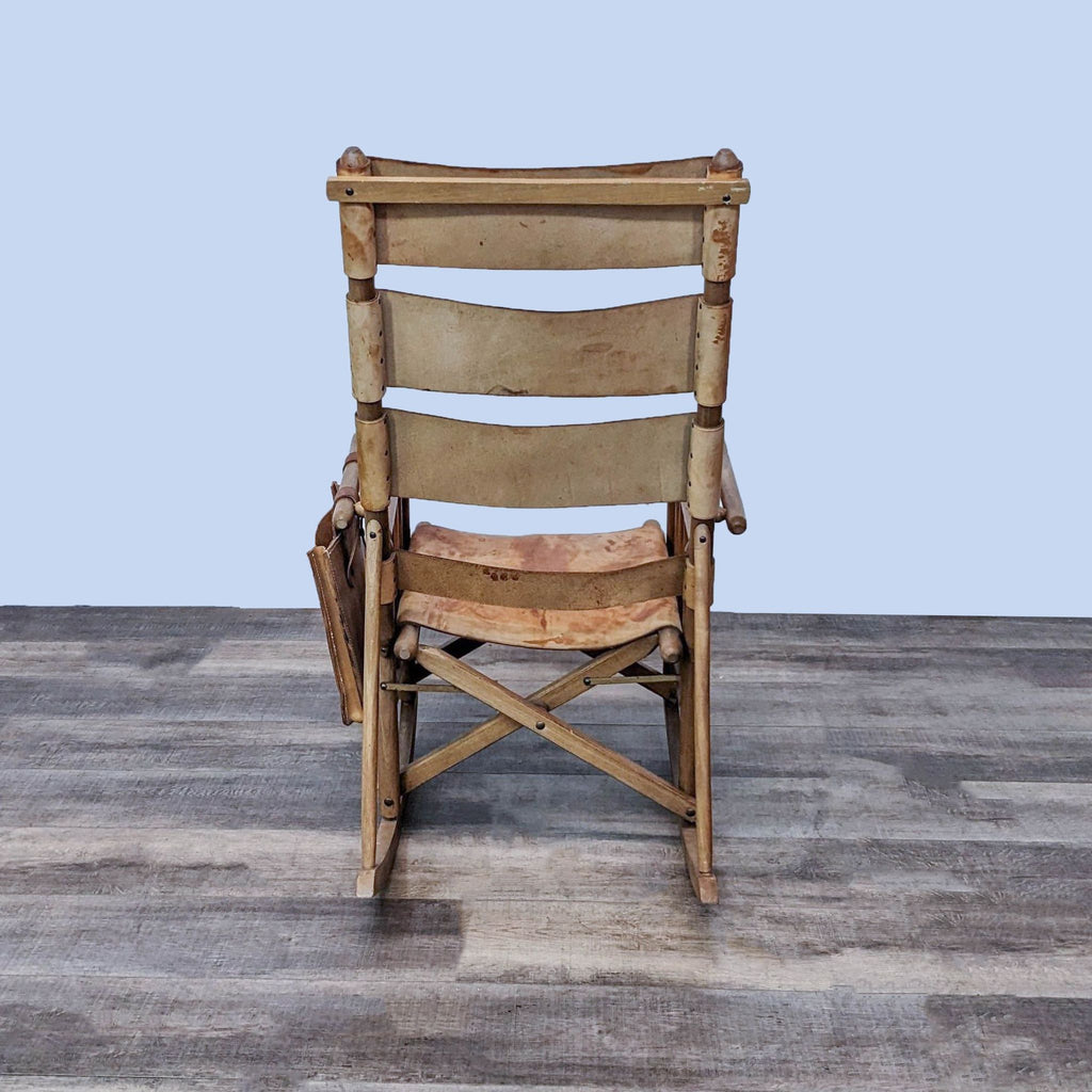 Back view of a folding rocking chair made of Caobilla wood and leather.