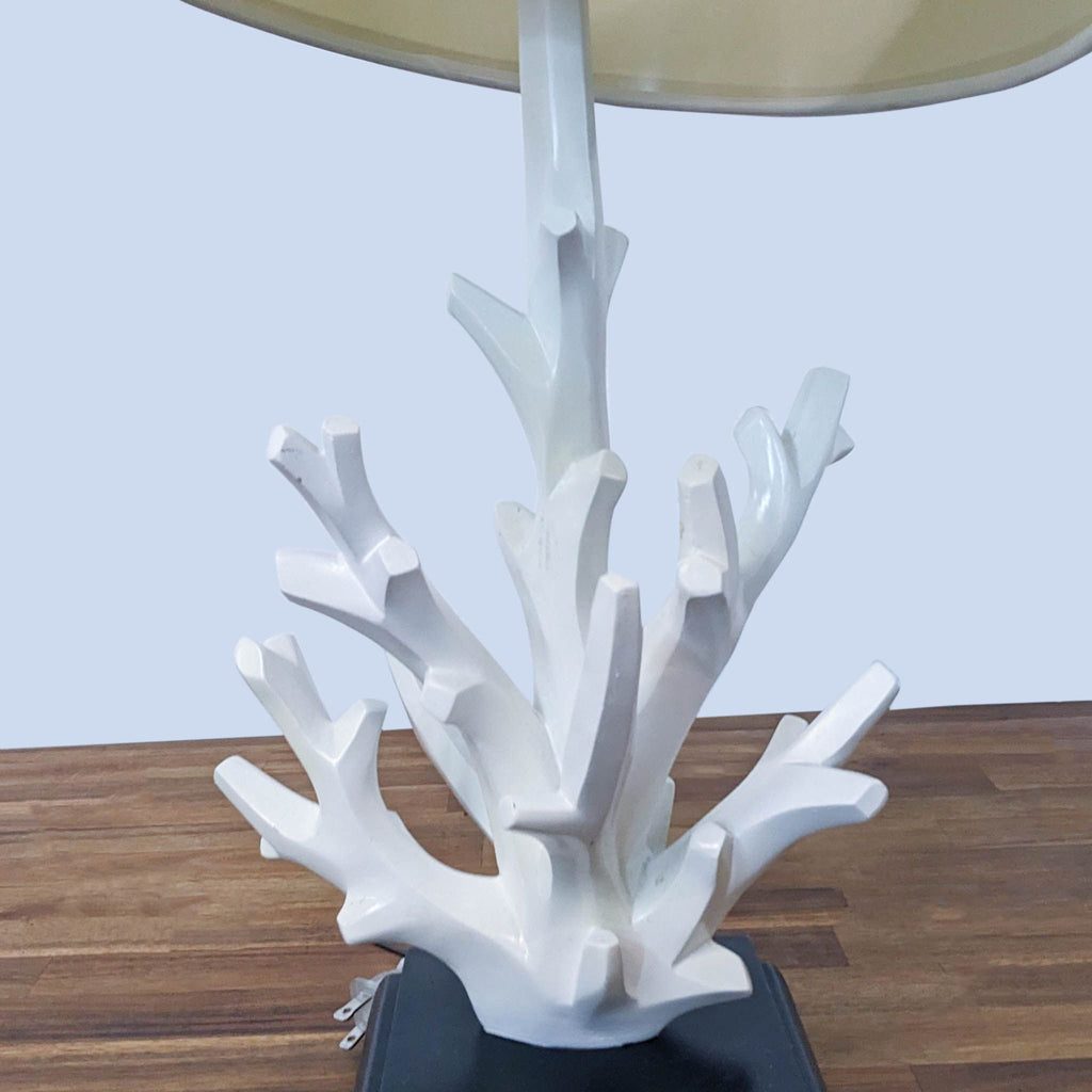 Detailed view of Reperch lamp's coral-like base against wooden tabletop.