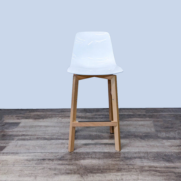 White plastic seat stool with a solid wood base, viewed from the front.