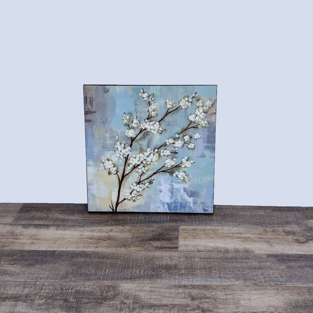 Canvas art featuring cherry blossoms with a textured background on a wooden floor.