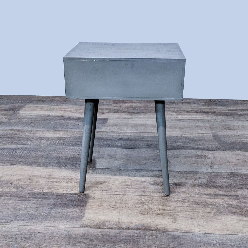 Side view of Reperch end table showcasing minimalist style and sturdy legs.
