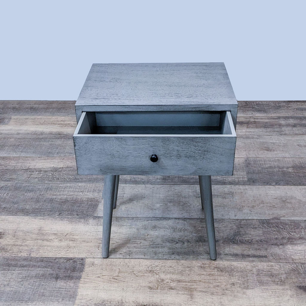 Gray Reperch end table with open drawer and sleek design.