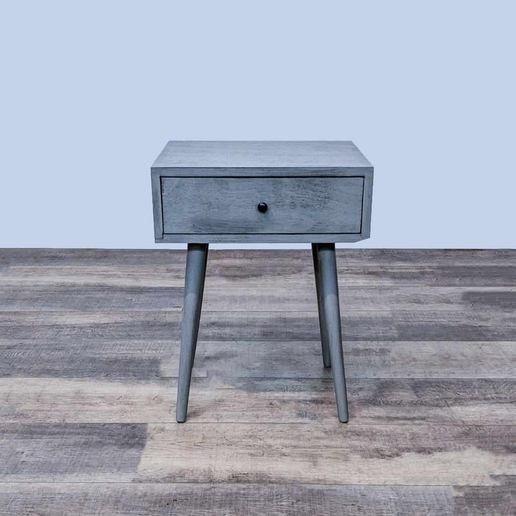 Reperch end table with single drawer and angled legs in gray finish.