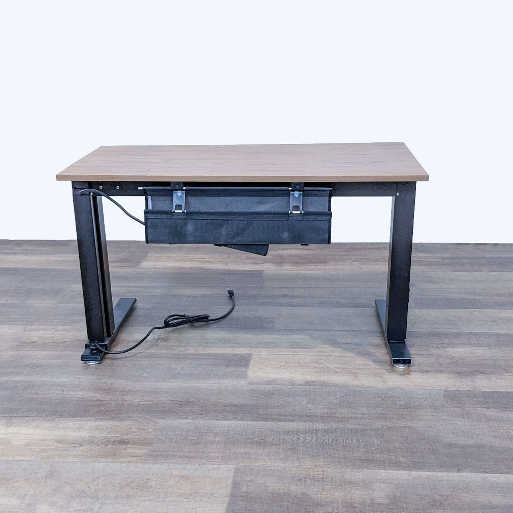Rear view of desk showing wood finish, black steel legs, and cables.