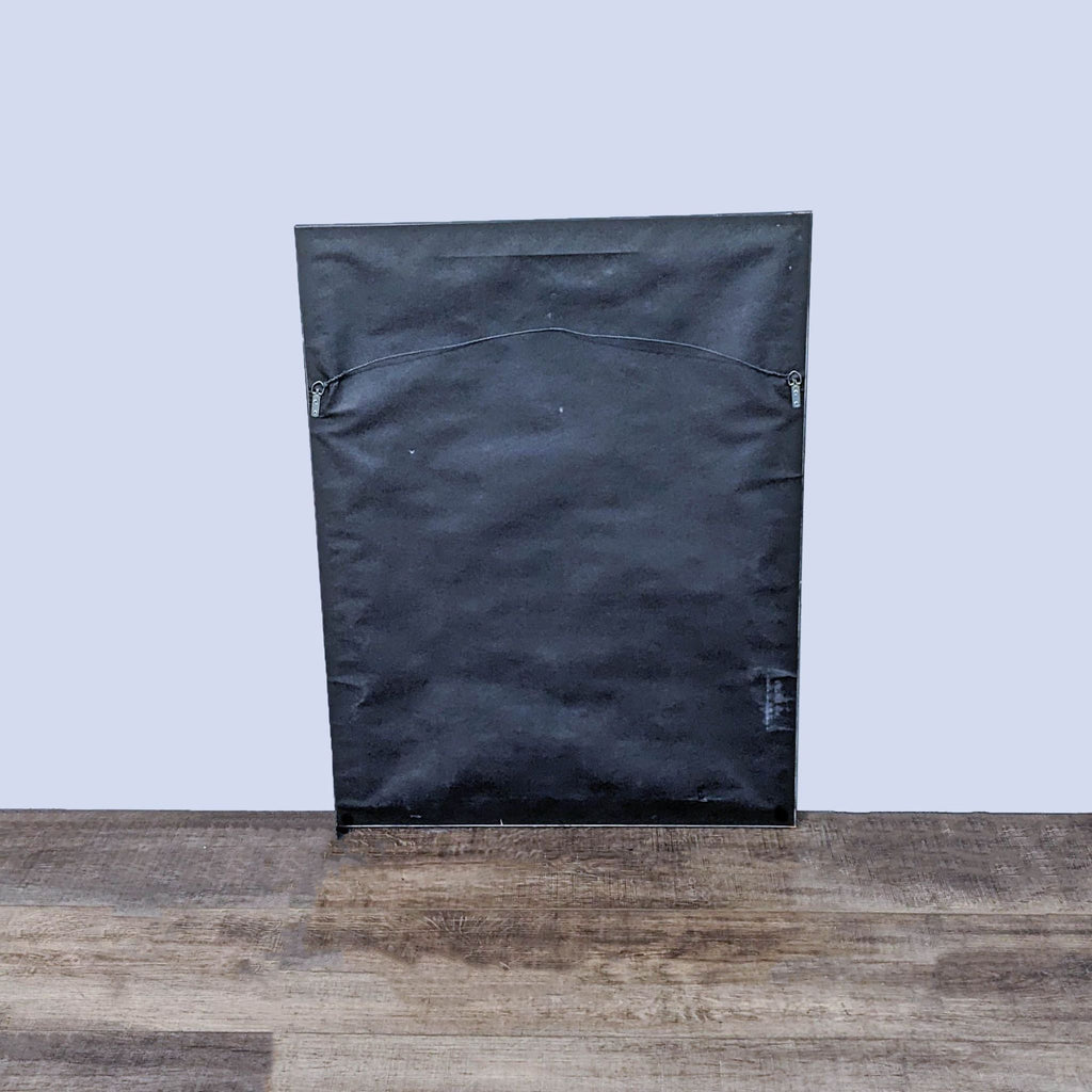 Back view of a Z-Gallerie mirror, featuring a plain black surface on a wooden floor.