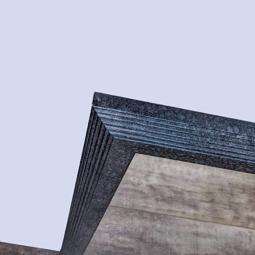 Close-up of granite gray frame on a Z-Gallerie mirror, showing layered texture.