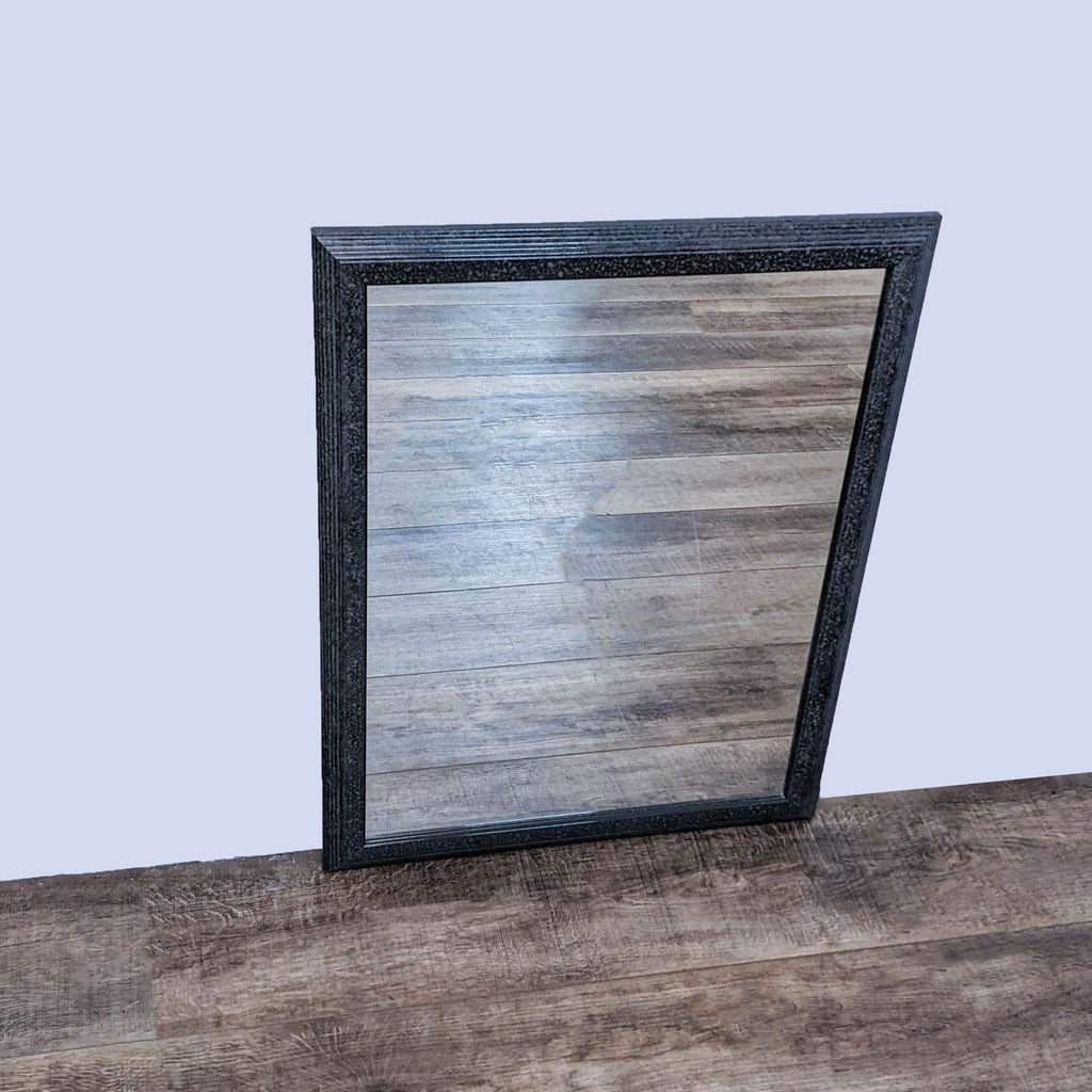 Z-Gallerie mirror with granite gray frame, leaning against a wooden floor.