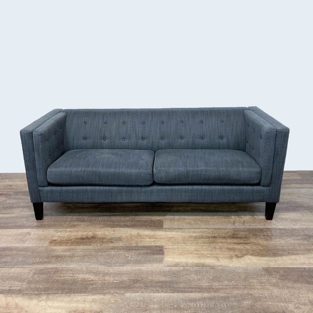 Front view of gray Reperch sofa featuring tufted design and dark finish feet.
