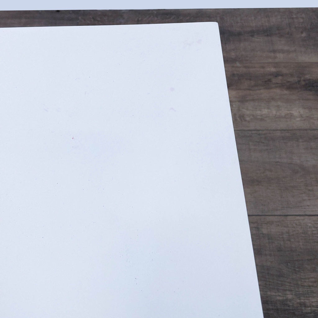 Close-up of the white top surface of a Mid-Century style end table by Reperch.