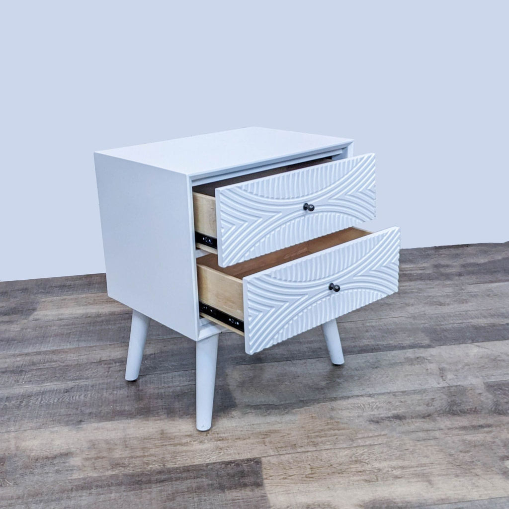 Mid-Century end table by Reperch, featuring open drawers with textured fronts on a wood floor.