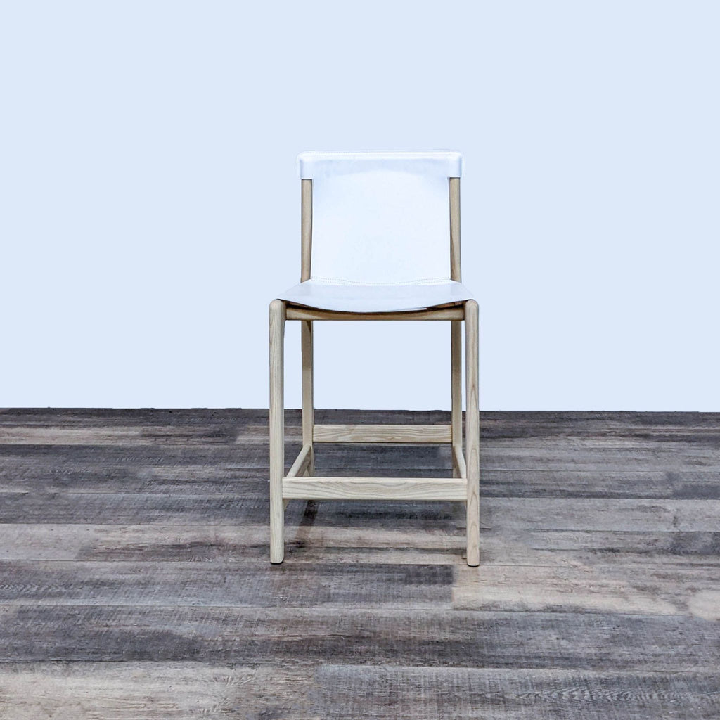 White leather sling stool with ashwood frame, front view.