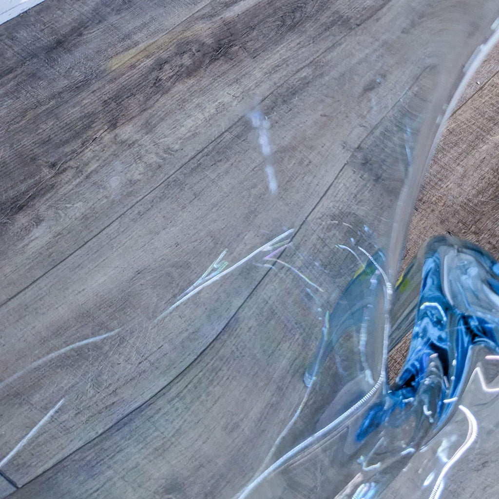 Close-up of the AVA chair highlighting its transparent polycarbonate texture.