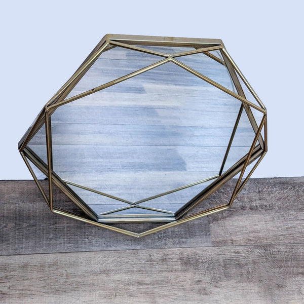 Modern mirror with a golden octagonal metal frame.