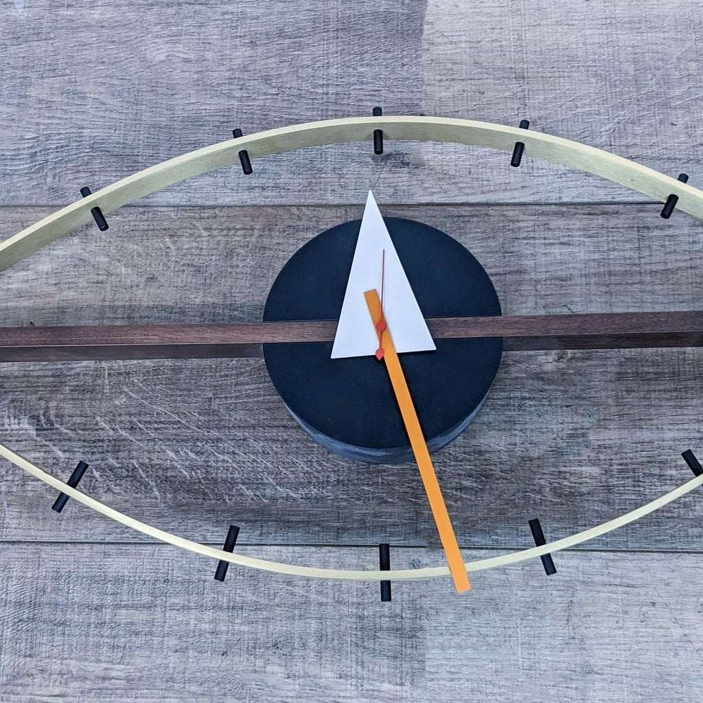 Close-up of Vitra Eye Clock's intricate design, highlighting its unique triangular hands and bold colors.
