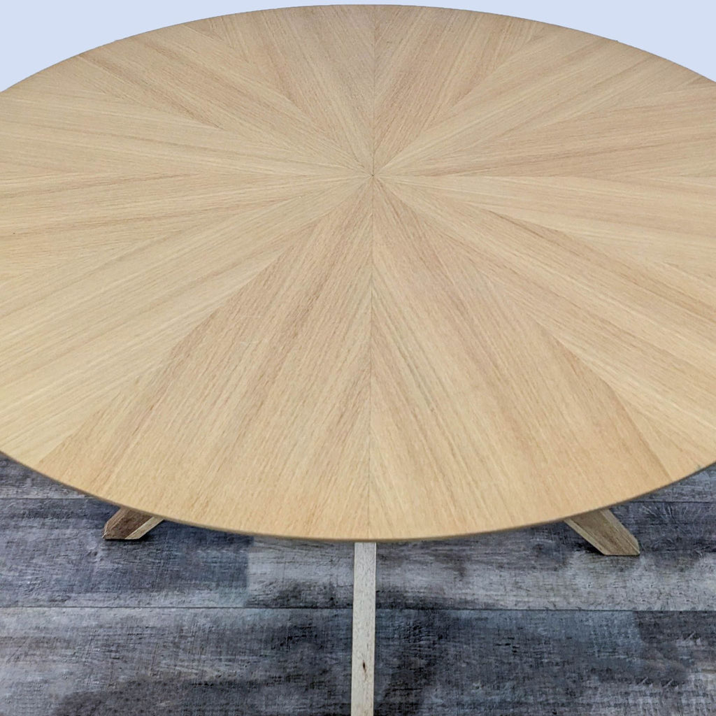 Close-up of the sunburst-patterned top of a Reperch dining table.