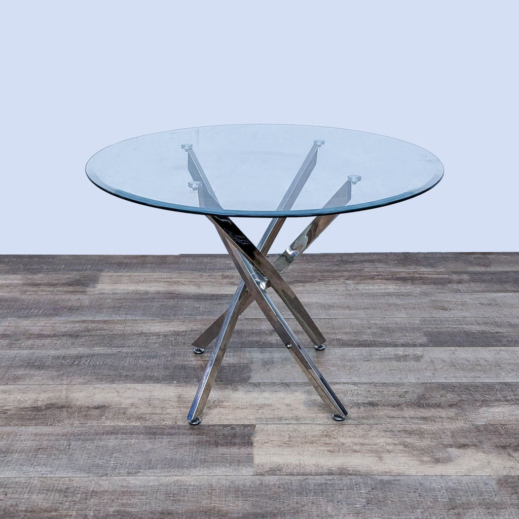 Contemporary table by Reperch with a sleek, clear glass top and unique chrome angular base.