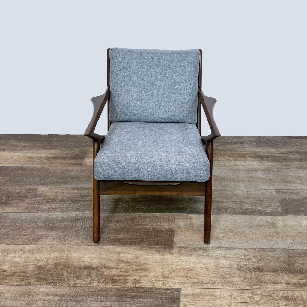 Mid-century modern accent chair with walnut frame and gray cushions.