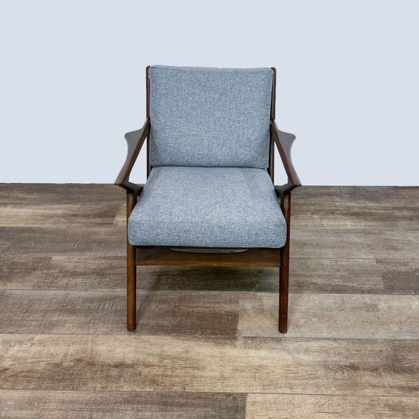 Mid-century modern accent chair with walnut frame and gray cushions.