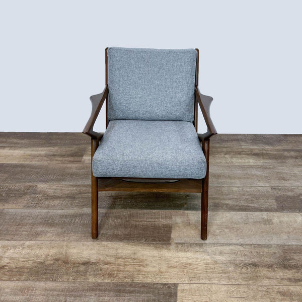 Mid-century modern chair with walnut frame and gray cushions, front view.