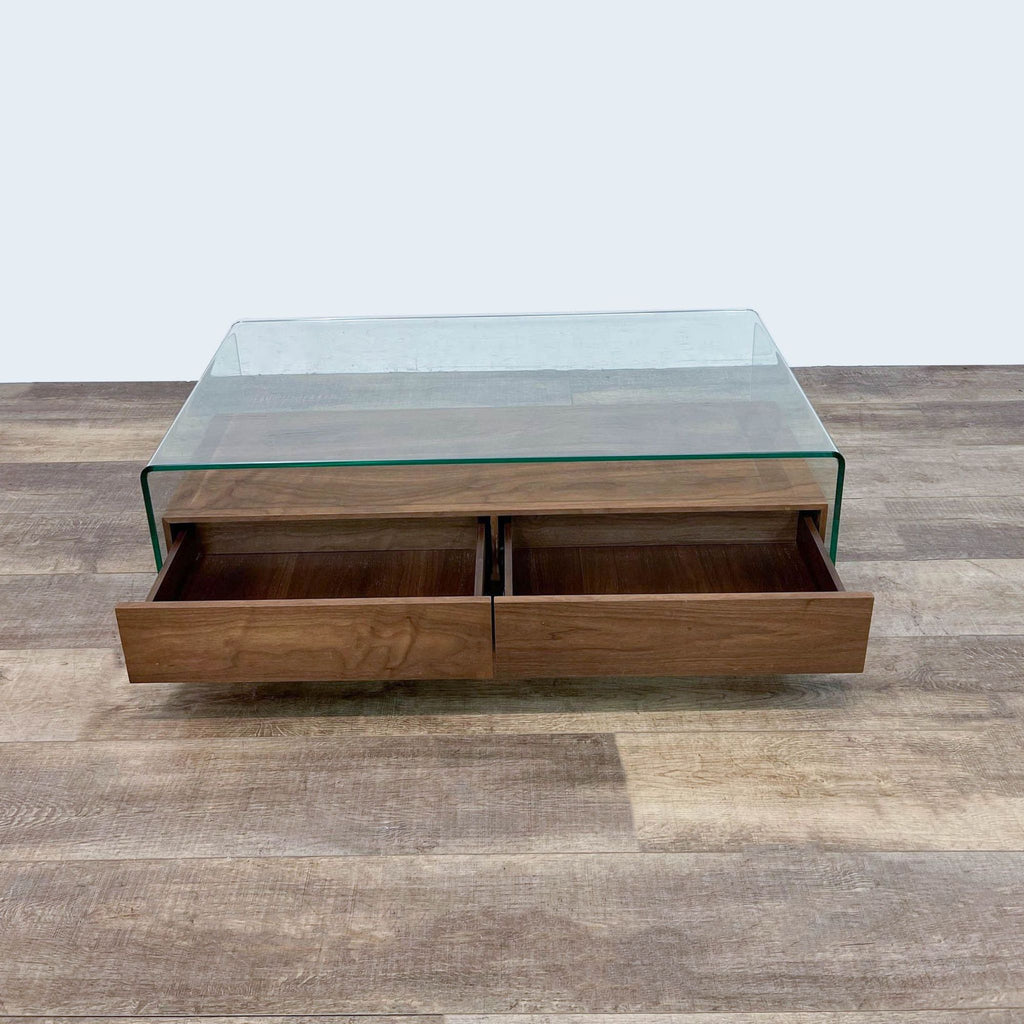 2. Two walnut drawers open under a glass coffee table by Zuo Modern.