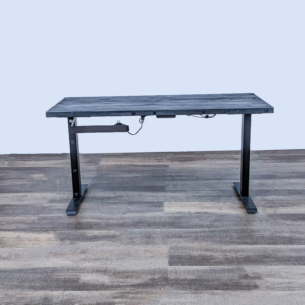 Black steel frame desk with motorized lift and black stained wood top.