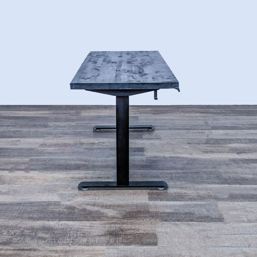 Reperch adjustable desk featuring a black stained top and steel frame.