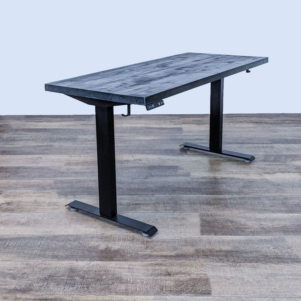 Custom black stained butcher block desk with motorized height adjustment.