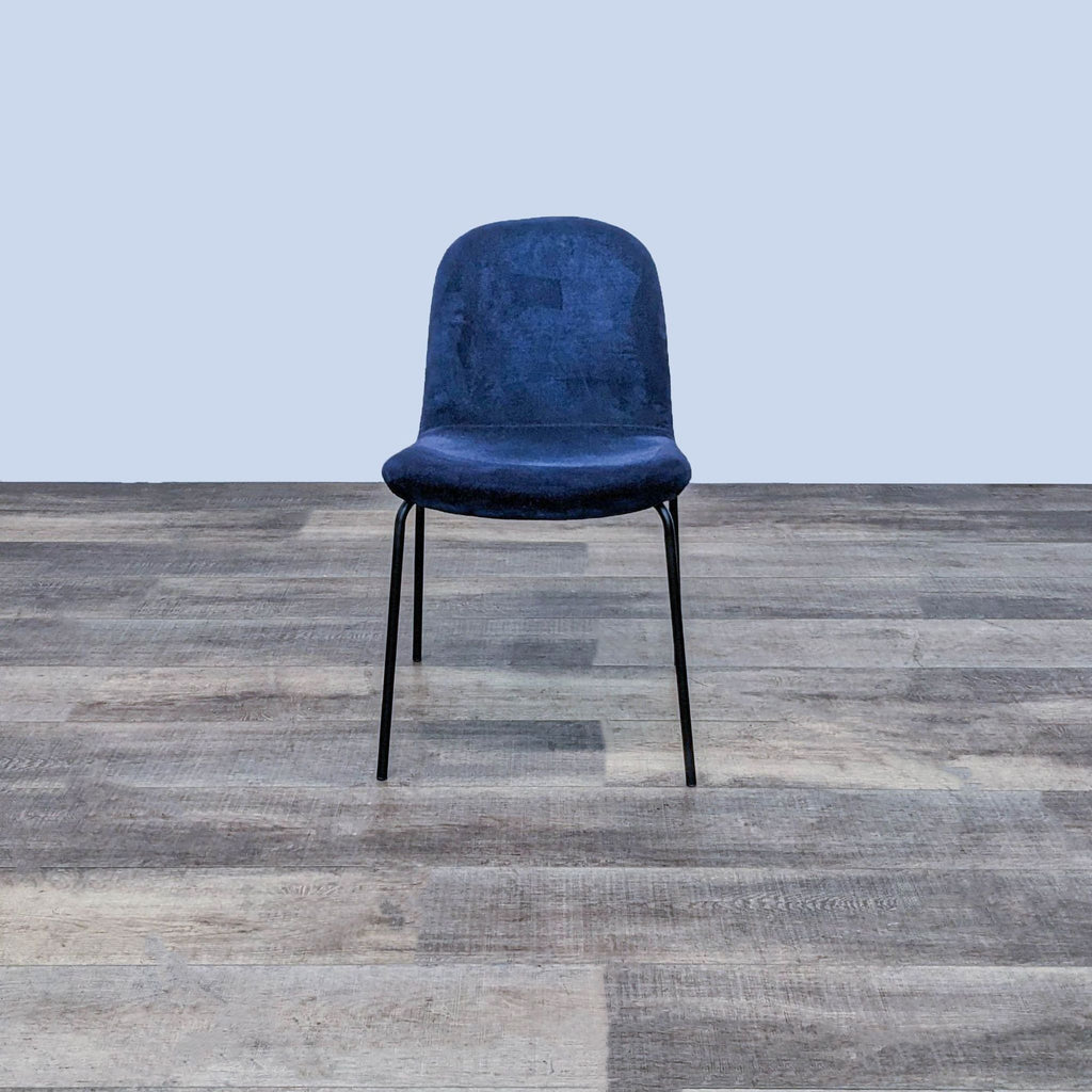 Front view of the Primativo side chair by CB2 with navy blue velvet seat and black steel frame.