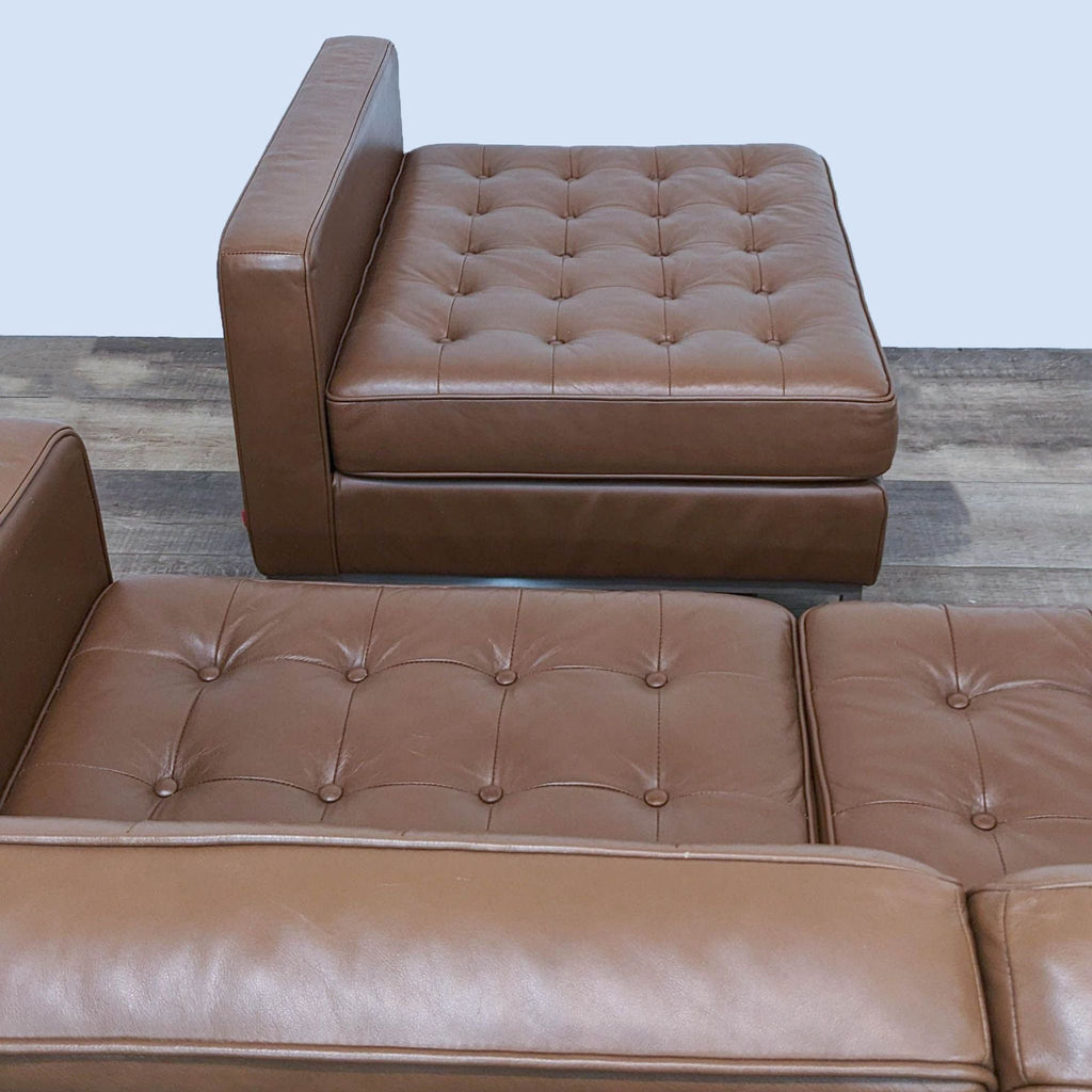 Top view of brown tufted leather sectional with reversible chaise, showing detailed upholstery.