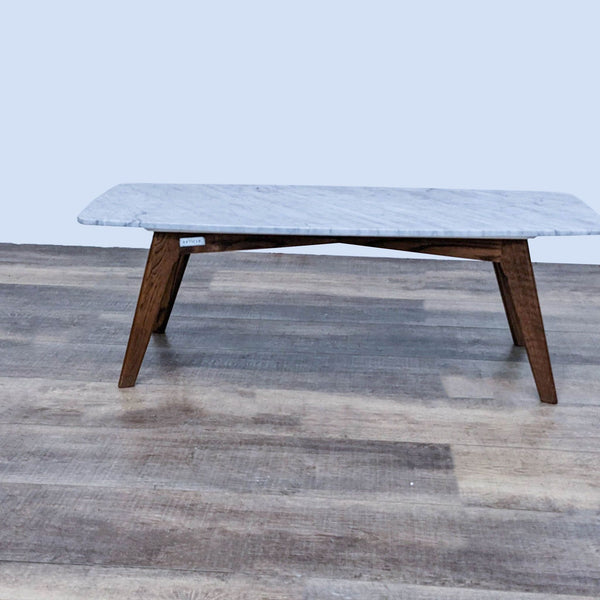 Marble coffee table by Article with white oak legs in walnut finish.