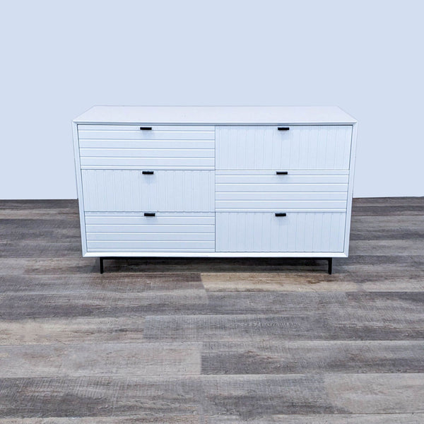 White dresser with horizontal and vertical ridges and black handles, on black metal legs by VIG Furniture.