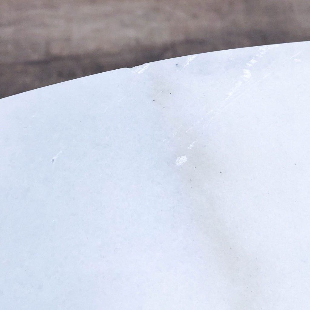 Close-up of the white marble tabletop showing subtle texture.  