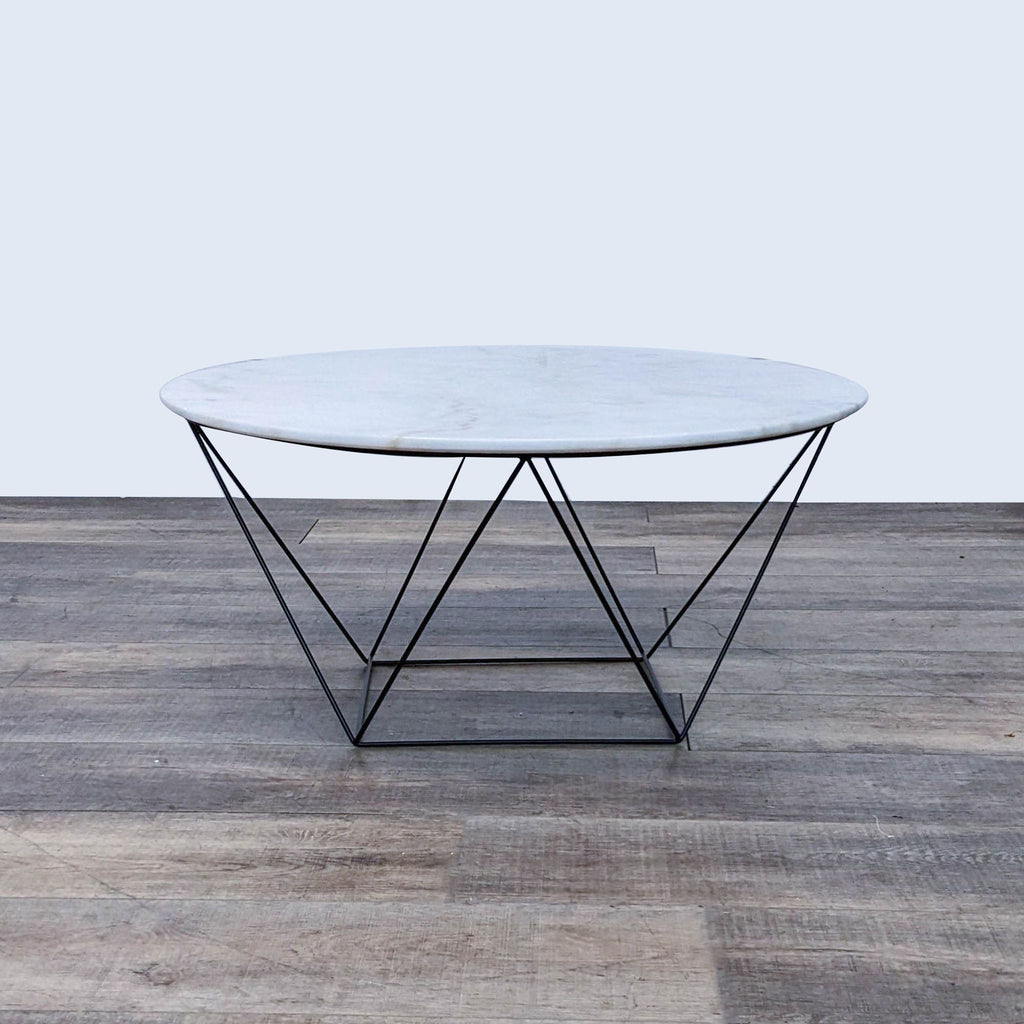 Round Reperch coffee table with marble top and geometric metal base.   