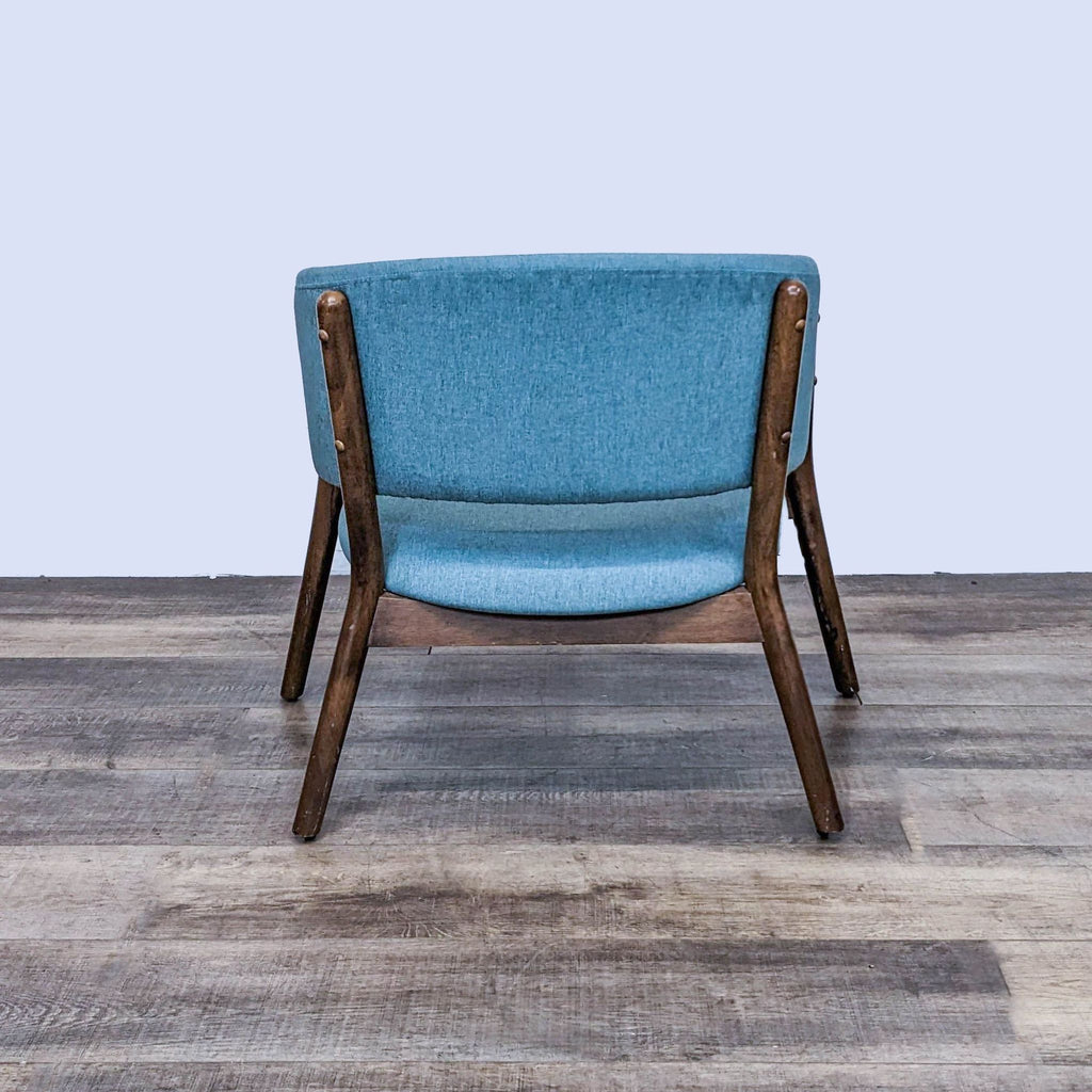 Back view of Zuo Modern's Chapel chair, featuring blue poly-linen upholstery and solid wood frame.