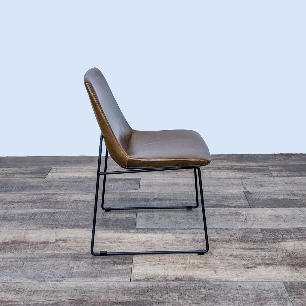 Side profile of Modway dining chair showing padded faux leather and sleek metal frame.