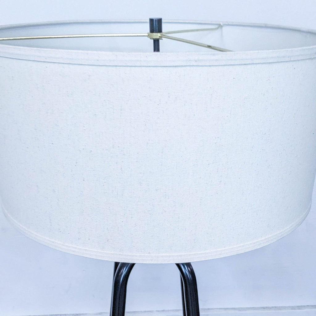 Detailed view of the Reperch lamp's cylindrical white shade with a black metal base.