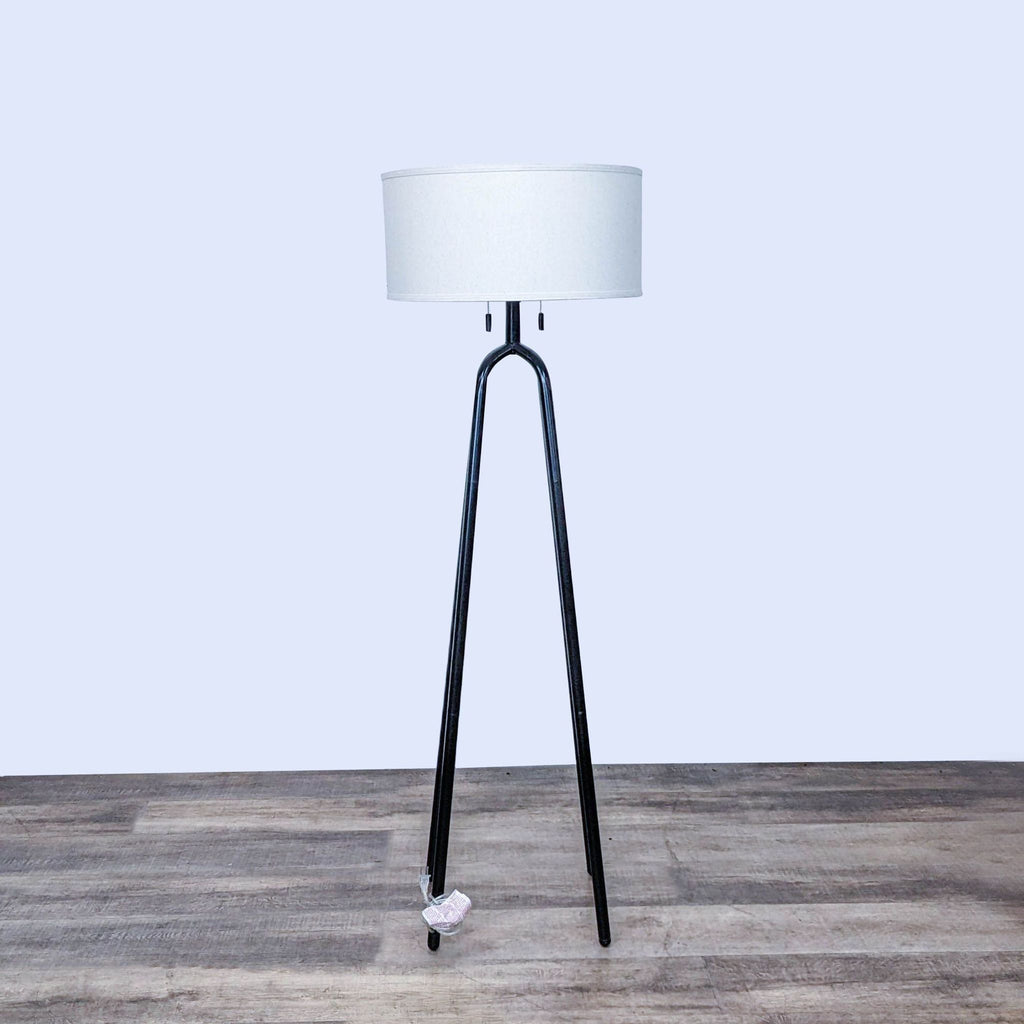 Modern Reperch floor lamp with a sleek black tripod base and a white drum shade.