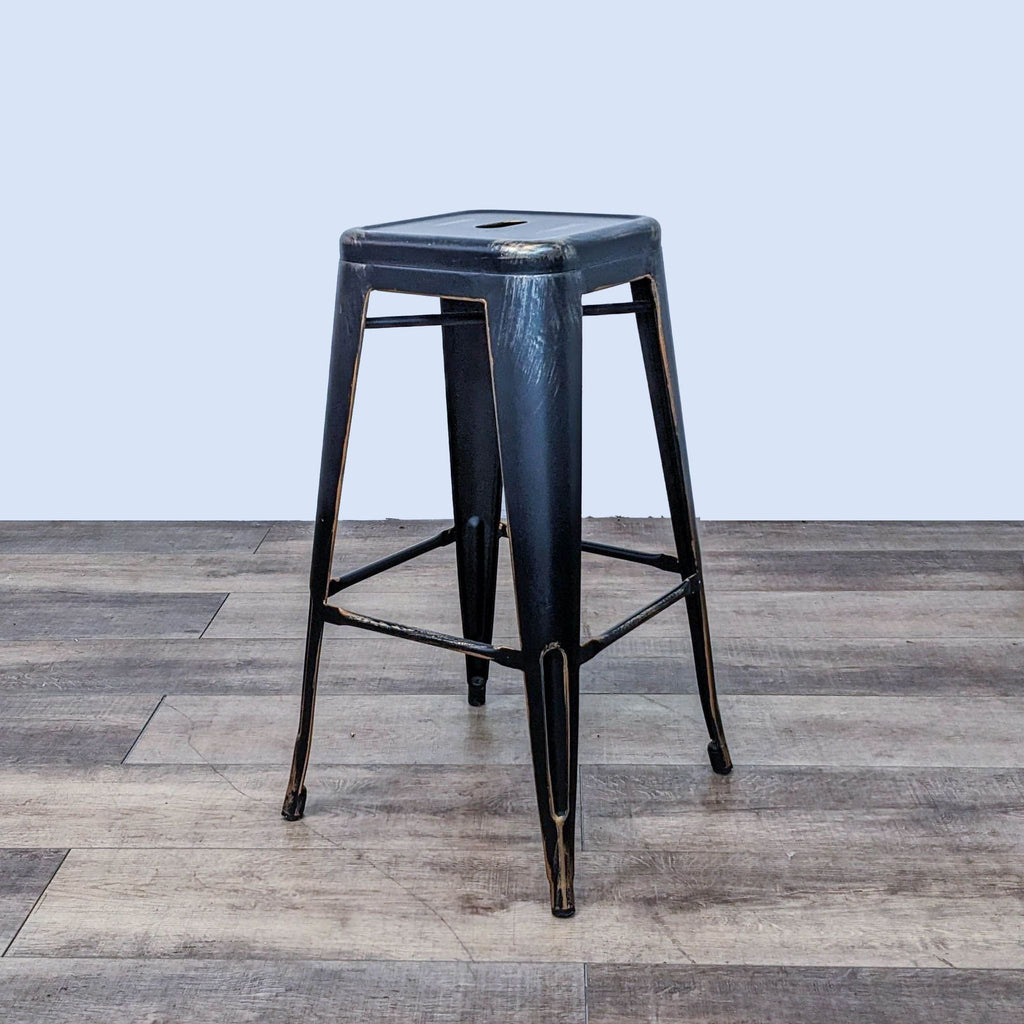 Stylish industrial black barstool, gold detailing, cutout seat.