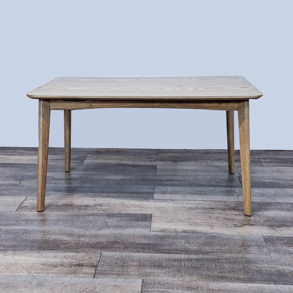 Reperch dining table with natural wood finish and rounded edges, mid-century modern style.