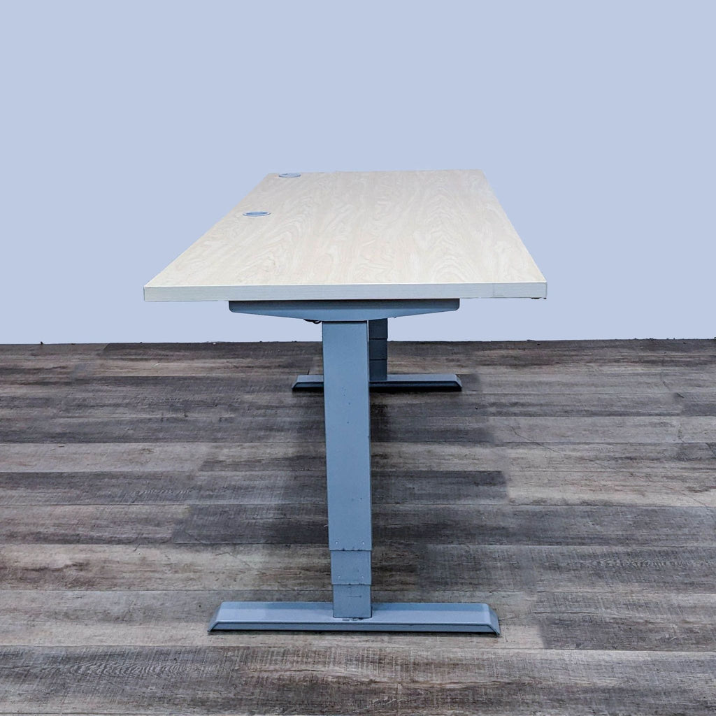 Side view of custom 72" desk, light finish on gray steel base.