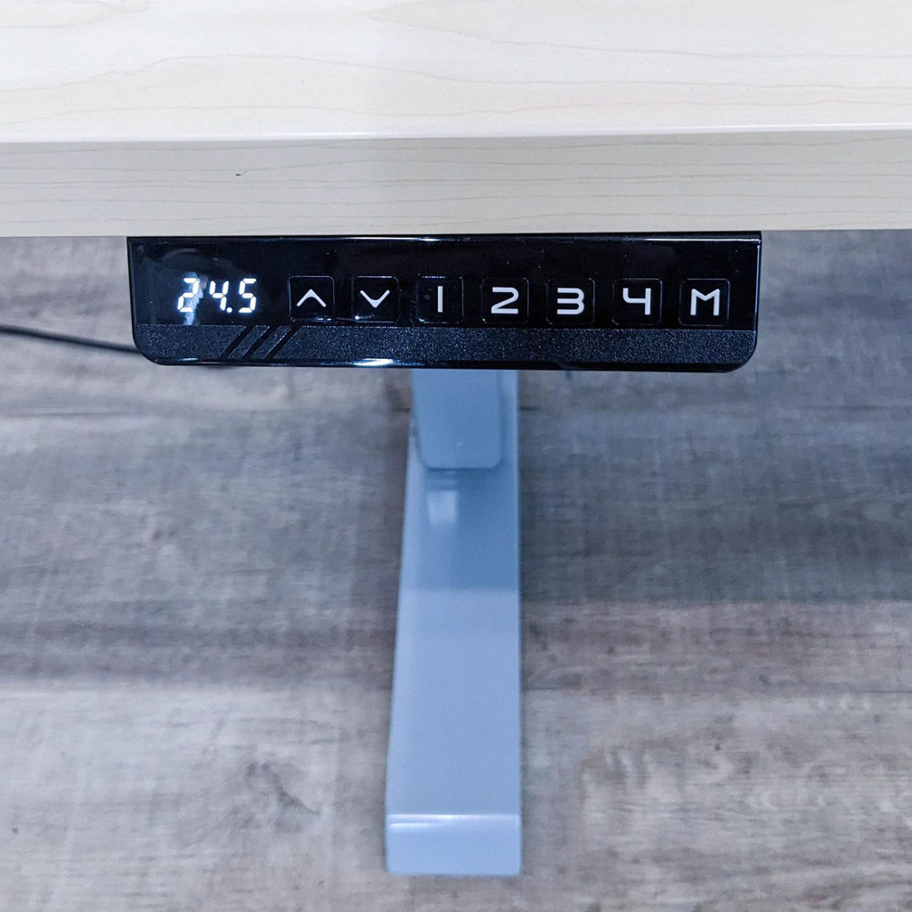 Close-up of programmable controls on a motorized desk.
