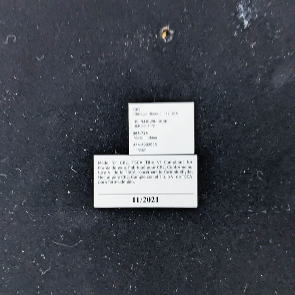 Label with product details for a CB2 nightstand, showing manufacturing information and date.