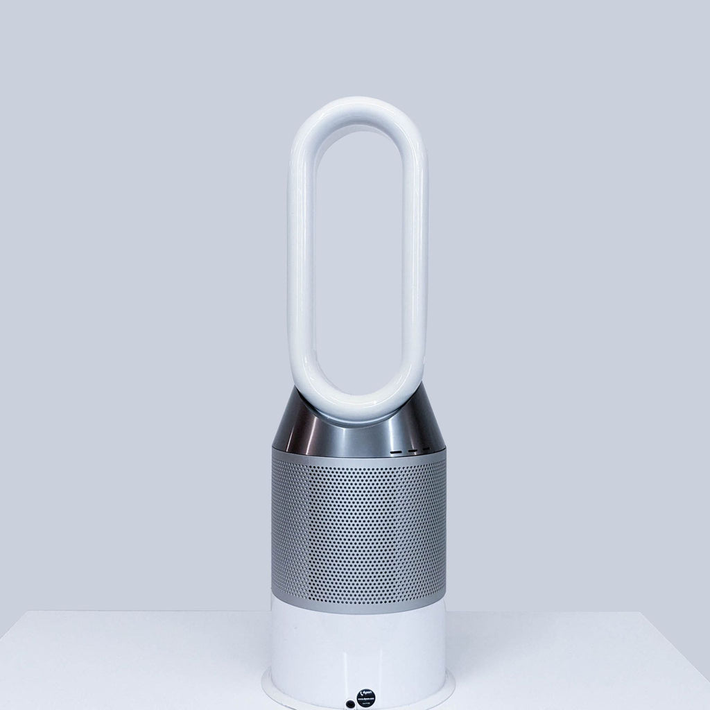 Dyson bladeless fan with a sleek white and silver finish on a table.