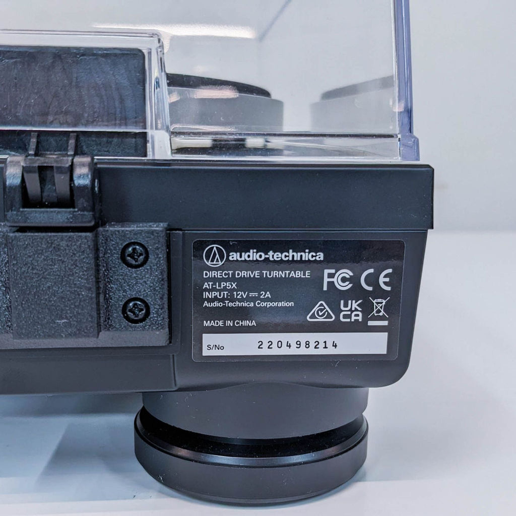 2. Close-up of the label on the Audio-Technica AT-LP5X turntable, displaying model and certification details.