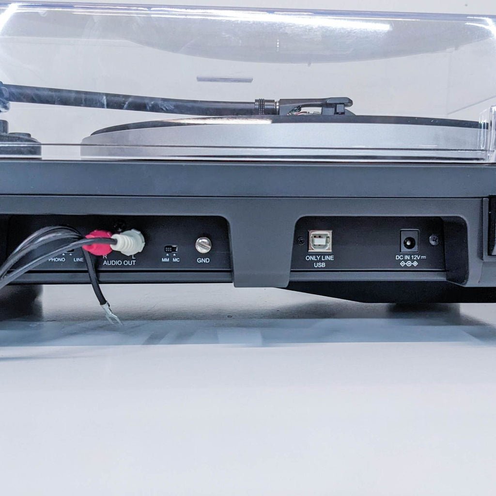 3. Rear view of Audio-Technica turntable showing audio outputs, USB, grounding, and DC power input ports.