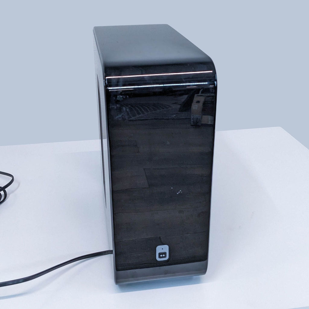 Side view of a slim Sonos speaker, showing a power cord attached at the back.