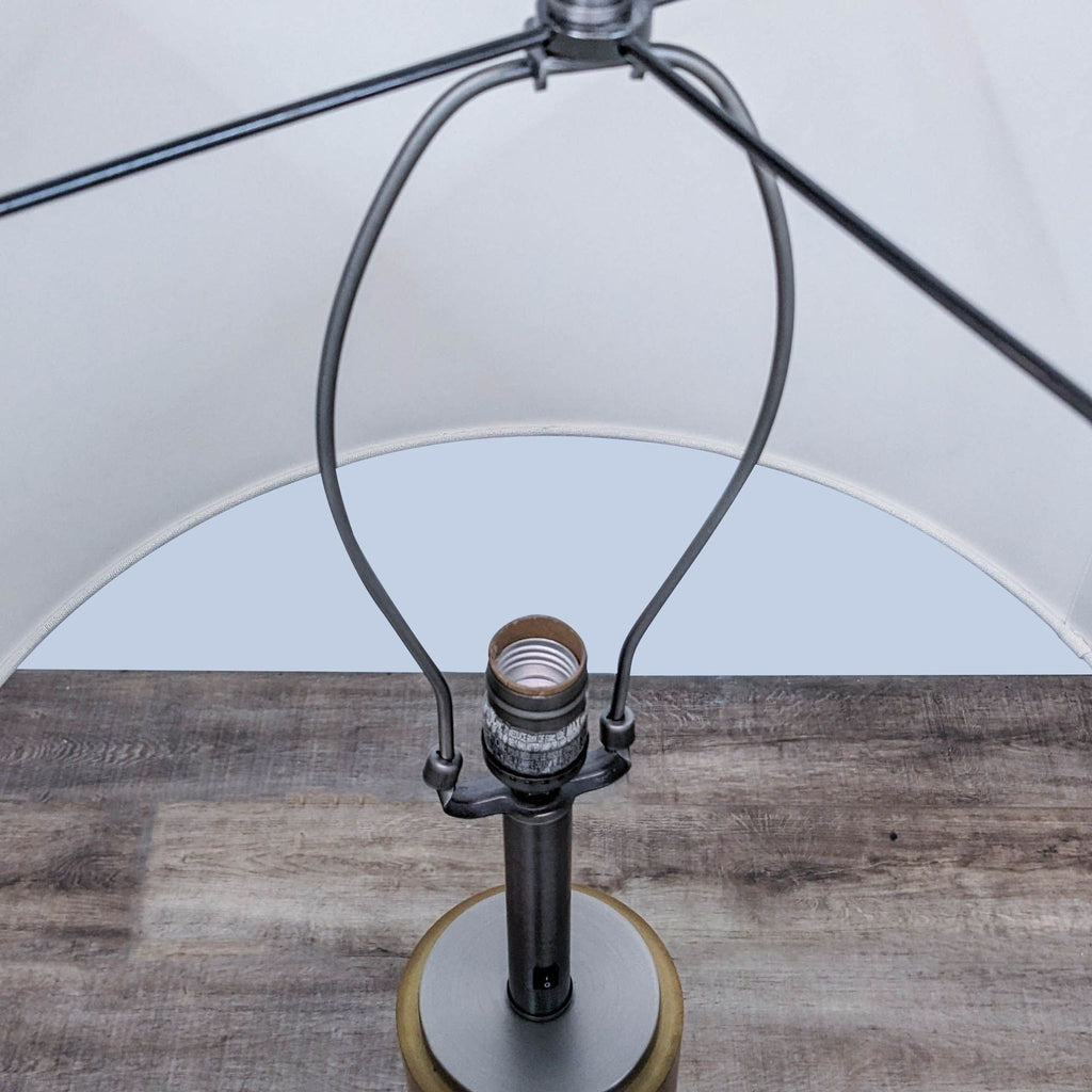 Close-up of the lamp's metal fixture and bulb socket from above.