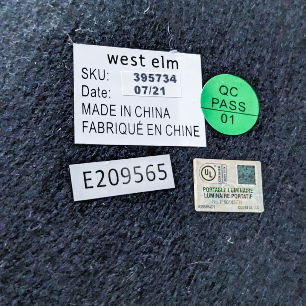 Brand label of West Elm lamp with manufacturing details and QC pass sticker.