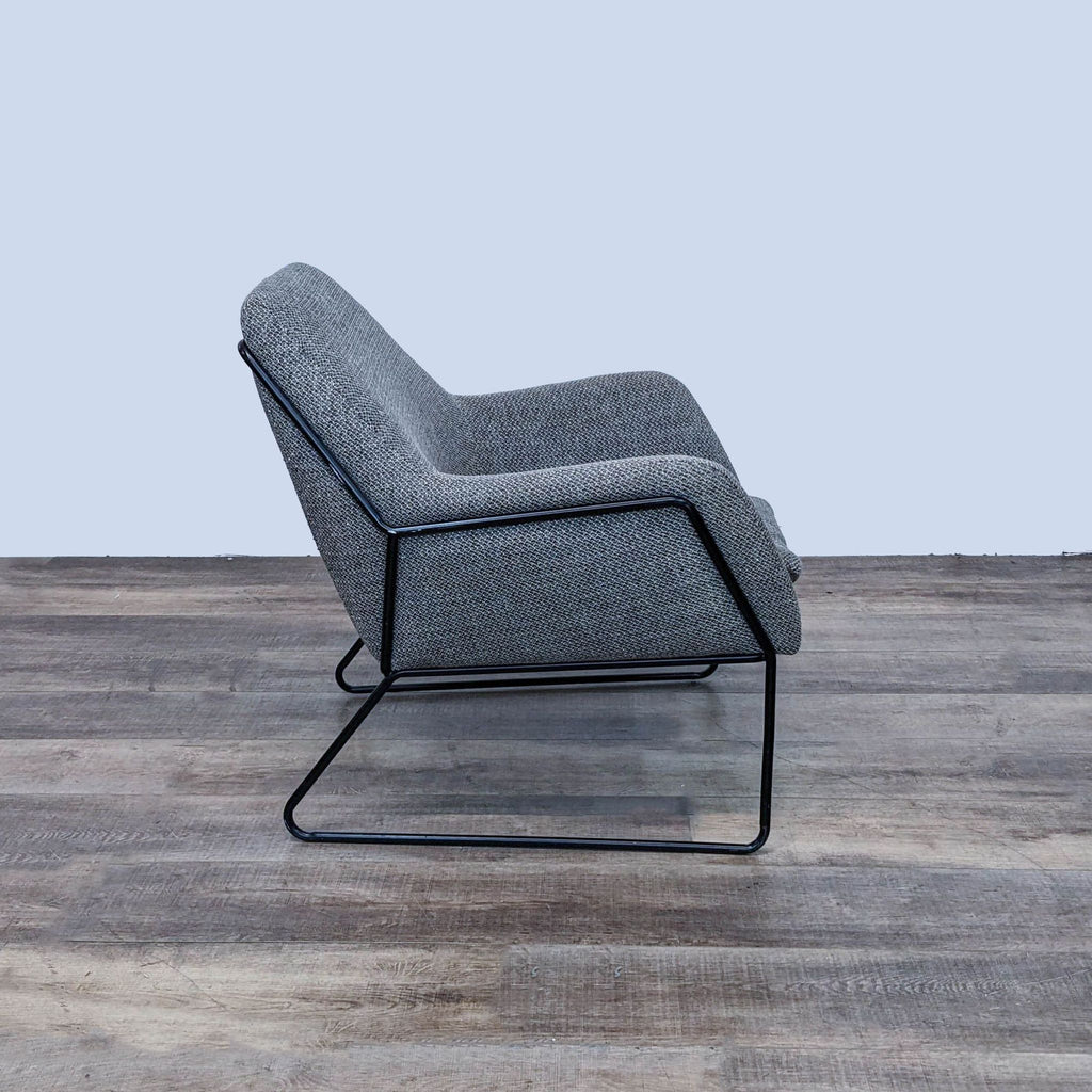 Side profile of the Forma chair, showcasing its angled seat and sleek metal frame design.